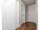 Hallway with white doors and wood-look flooring at 4187 Mistymorn Way, Powder Springs, GA 30127