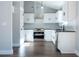 Eat-in kitchen with stainless steel appliances, sleek white cabinetry, and hardwood flooring at 4187 Mistymorn Way, Powder Springs, GA 30127