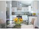 Eat-in kitchen with stainless steel appliances, sleek white cabinetry, and a view to the garden at 4187 Mistymorn Way, Powder Springs, GA 30127