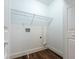 Clean laundry room with wood-look floors, white trim, and utility connections at 4187 Mistymorn Way, Powder Springs, GA 30127