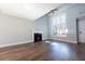 Sun-filled living room featuring hardwood floors, a cozy fireplace, and a large window at 4187 Mistymorn Way, Powder Springs, GA 30127