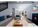 Bright living room featuring hardwood floors, a cozy fireplace, and comfortable seating at 4187 Mistymorn Way, Powder Springs, GA 30127