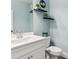 Small powder room with white vanity and light blue walls at 445 Carmichael Cir, Canton, GA 30115