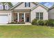 Front porch of a two-story house with brick and gray siding at 445 Carmichael Cir, Canton, GA 30115