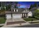 Two-story home with three-car garage and manicured lawn at 445 Carmichael Cir, Canton, GA 30115