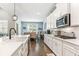 Modern kitchen with white cabinets, large island, and stainless steel appliances at 445 Carmichael Cir, Canton, GA 30115