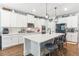 Modern kitchen with white cabinets, large island, and stainless steel appliances at 445 Carmichael Cir, Canton, GA 30115