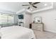 Main bedroom with king-size bed, sitting area and ceiling fan at 445 Carmichael Cir, Canton, GA 30115