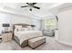 Main bedroom with king-size bed, sitting area and ceiling fan at 445 Carmichael Cir, Canton, GA 30115