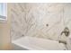 Updated bathroom with marble tile and a new bathtub at 1903 Meadow Ln, Decatur, GA 30032