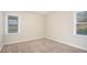 Bright bedroom with neutral walls and carpet, featuring two windows at 1903 Meadow Ln, Decatur, GA 30032