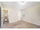 Well-lit bedroom with carpet and access to a hallway at 1903 Meadow Ln, Decatur, GA 30032