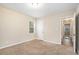 Spacious bedroom with carpet flooring and access to hallway at 1903 Meadow Ln, Decatur, GA 30032