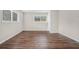 Simple bedroom with dark wood floors and window at 1983 Wee Kirk Se Rd, Atlanta, GA 30316