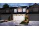 Charming townhome featuring a two-car garage, stone accents, and a well-maintained lawn at 289 Bald Ave, Stockbridge, GA 30253