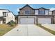 Two-story townhome with attached two-car garage, and landscaped front yard at 301 White Tail Rd, Stockbridge, GA 30253