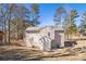 View of the rear of the home featuring fenced yard, siding, and mature trees at 3884 Blue Granite Way, Conley, GA 30288