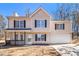 Two-story house with beige siding, a porch and a driveway at 3884 Blue Granite Way, Conley, GA 30288