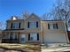 Two-story house with beige siding, a garage, and a small porch at 3884 Blue Granite Way, Conley, GA 30288