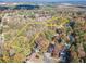 Aerial view of a large lot surrounded by woods and houses at 2612 Country Club Se Dr, Conyers, GA 30013