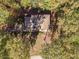 House nestled in a wooded lot with a large backyard at 2612 Country Club Se Dr, Conyers, GA 30013