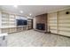 Finished basement with a brick fireplace and ample built-in shelving at 2612 Country Club Se Dr, Conyers, GA 30013