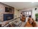 Virtually staged basement recreation area with a brick fireplace at 2612 Country Club Se Dr, Conyers, GA 30013