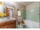 Charming bathroom with green tiled walls and wood vanity at 2612 Country Club Se Dr, Conyers, GA 30013