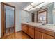 Double vanity bathroom with wood cabinets and access to a large closet at 2612 Country Club Se Dr, Conyers, GA 30013