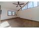 Spacious bedroom with a ceiling fan, large windows, and carpet flooring at 2612 Country Club Se Dr, Conyers, GA 30013