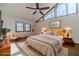 Main bedroom with large windows, ceiling fan and stylish mid-century modern furniture at 2612 Country Club Se Dr, Conyers, GA 30013