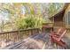 Large deck overlooking wooded area with red chairs at 2612 Country Club Se Dr, Conyers, GA 30013