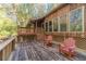 Spacious deck with red adirondack chairs and wooded views at 2612 Country Club Se Dr, Conyers, GA 30013