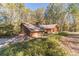 Brick and wood house with attached garage and wooded lot at 2612 Country Club Se Dr, Conyers, GA 30013