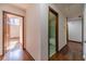 Hardwood floors in the hallway, with doors leading to bedrooms and bathroom at 2612 Country Club Se Dr, Conyers, GA 30013