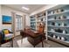 Bright home office features built-in shelving and a large desk at 2612 Country Club Se Dr, Conyers, GA 30013
