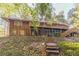 Back of house, showcasing a large deck and screened porch at 2612 Country Club Se Dr, Conyers, GA 30013