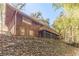 Back of house with deck and surrounding woods at 2612 Country Club Se Dr, Conyers, GA 30013