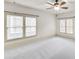 Bright bedroom featuring ceiling fan and neutral carpeting at 147 Hubbard Rd, Woodstock, GA 30188