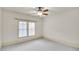 Bright bedroom featuring neutral walls, carpet, and two windows at 147 Hubbard Rd, Woodstock, GA 30188