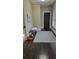 Spacious hallway with dark hardwood floors and a bench at 147 Hubbard Rd, Woodstock, GA 30188