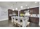 Spacious kitchen with dark cabinetry, granite island, and stainless steel appliances at 147 Hubbard Rd, Woodstock, GA 30188