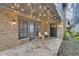 Stone patio with string lights, seating, and access to the home at 147 Hubbard Rd, Woodstock, GA 30188