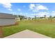 Green backyard with a concrete patio overlooking lawn and neighborhood at 3340 Redwood Ct, Covington, GA 30016