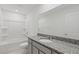 Clean bathroom featuring granite countertops, a large mirror, and a bathtub/shower combo at 3340 Redwood Ct, Covington, GA 30016