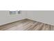 Bright bedroom with hardwood flooring, white walls, and natural light streaming through a window at 3340 Redwood Ct, Covington, GA 30016