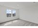 Bright bedroom with plush gray carpeting and a pair of windows offering community views at 3340 Redwood Ct, Covington, GA 30016