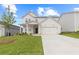 Charming two-story home with manicured lawn, inviting front porch, and attached two-car garage at 3340 Redwood Ct, Covington, GA 30016