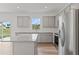Modern kitchen featuring an island, stainless steel appliances, granite countertops, and gray cabinets at 3340 Redwood Ct, Covington, GA 30016