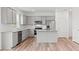 Modern kitchen with gray cabinets, granite countertops, stainless steel appliances, and hardwood flooring at 3340 Redwood Ct, Covington, GA 30016